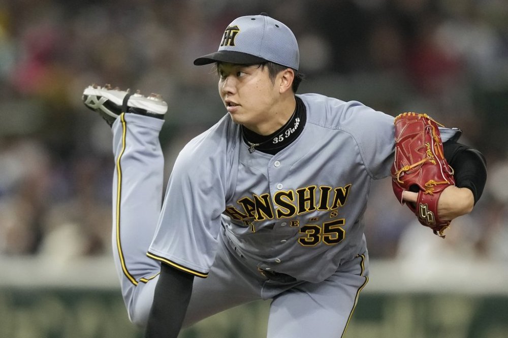 Hanshin Tigers pitcher Hiroto Saiki works against the Los Angeles Dodgers during the fifth inning in an MLB Japan Series exhibition baseball game, Sunday, March 16, 2025, in Tokyo. (AP Photo/Hiro Komae)