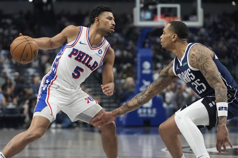 Philadelphia 76ers guard Quentin Grimes (5) dribbles against Dallas Mavericks forward P.J. Washington (25) during the first half of an NBA basketball game in Dallas, Sunday, March 16, 2025. (AP Photo/LM Otero)