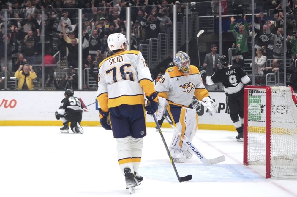 Nashville Predators goaltender Justus Annunen (29) and defenseman Brady Skjei (76) react as Los Angeles Kings right wing Quinton Byfield (55) celebrates his overtime goal in an NHL hockey game Saturday, March 15, 2025, in Los Angeles. (AP Photo/Jae C. Hong)