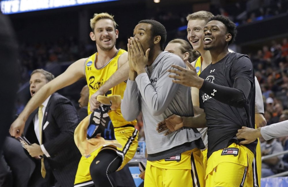 FILE - UMBC players celebrate a teammate's basket during the second half against Virginia in a first-round game in the NCAA men's college basketball tournament in Charlotte, N.C., March 16, 2018. (AP Photo/Gerry Broome, File)