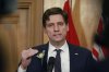 Premier David Eby speaks to reporters from his office following the throne speech at the legislature in Victoria, Tuesday, Feb. 18, 2025. THE CANADIAN PRESS/Chad Hipolito