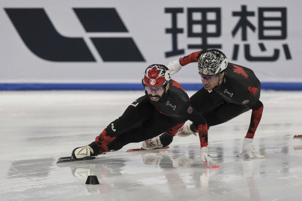 Steven Dubois of Canada is followed by his teammate William Dandjinou as they compete in the Men's 1000m Finals for the ISU World Short Track Championships held at the Capital Indoor Stadium in Beijing, Sunday, March 16, 2025. THE CANADIAN PRESS/AP-Andy Wong