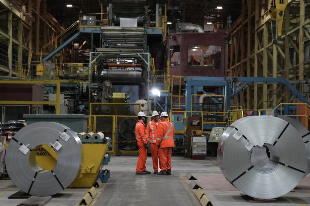 Steel workers gather for an announcement at the ArcelorMittal Dofasco Steel Plant in Hamilton, on Friday, February 14, 2025. THE CANADIAN PRESS/Chris Young