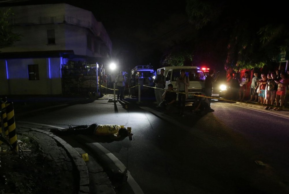 FILE - The body of alleged drug user Marcelo Salvador lies on the pavement after being shot by unidentified men in Las Pinas, south of Manila, Philippines, Sept. 5, 2016. (AP Photo/Aaron Favila, File)