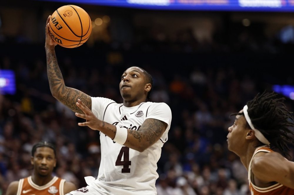 Texas A&M guard Wade Taylor IV (4) heads to the basket against Texas during the second half of an NCAA college basketball game in the second round of the Southeastern Conference tournament, Thursday, March 13, 2025, in Nashville, Tenn. (AP Photo/Wade Payne)