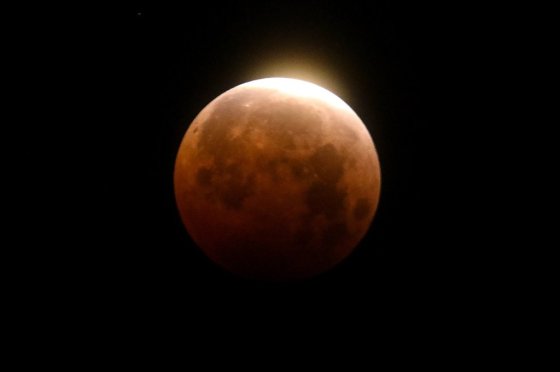 Light shines from a total lunar eclipse over Santa Monica Beach in 2021. (Ringo H.W. Chiu / The Associated Press files)