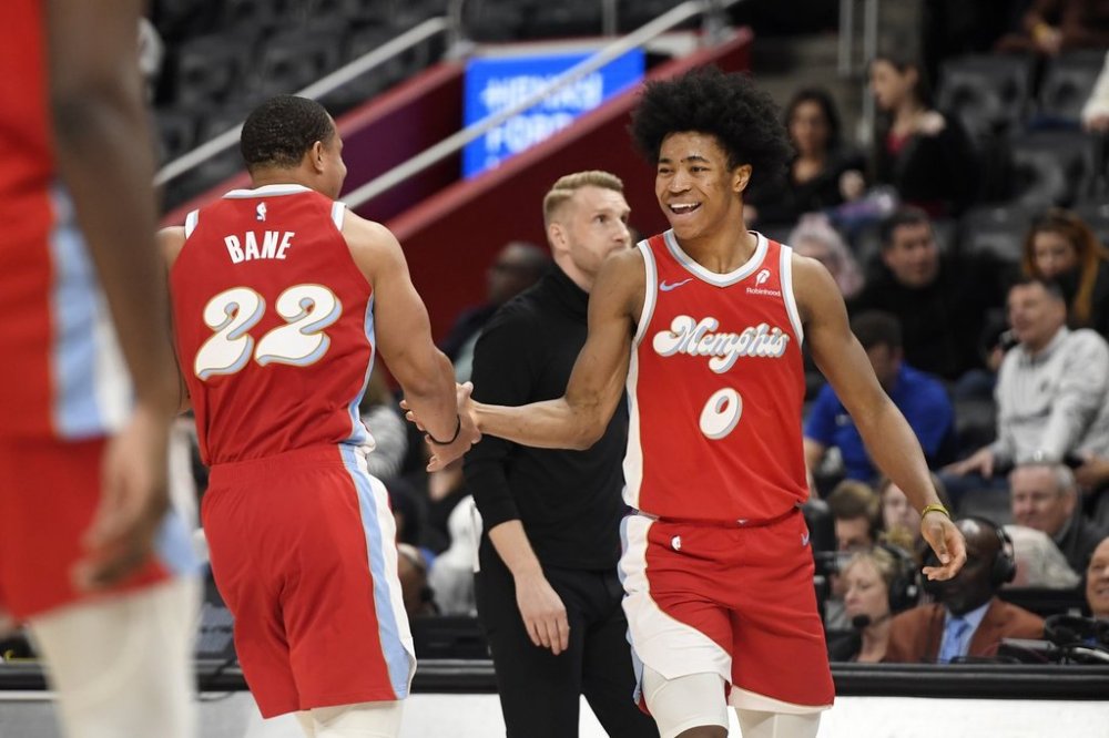 Memphis Grizzlies forward Jaylen Wells, right, and guard Desmond Bane (22) congratulate each other near the end of the second half of an NBA basketball game, Saturday, April 5, 2025, in Detroit. (AP Photo/Jose Juarez)
