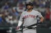 Boston Red Sox's Rafael Devers heads to the dugout after striking out during the ninth inning of a baseball game against the Texas Rangers, Saturday, March 29, 2025, in Arlington, Texas. (AP Photo/LM Otero)
