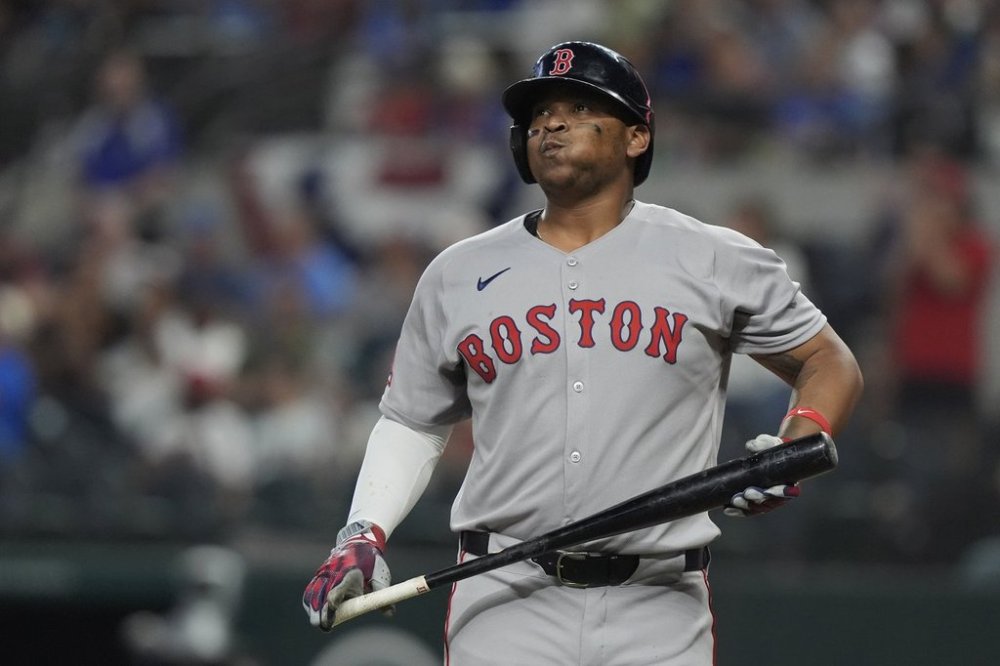 Boston Red Sox's Rafael Devers heads to the dugout after striking out during the ninth inning of a baseball game against the Texas Rangers, Saturday, March 29, 2025, in Arlington, Texas. (AP Photo/LM Otero)