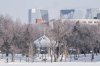 A man and a dog walk the path around Wascana Lake, flanked by downtown Regina on Thursday Feb. 18, 2021. THE CANADIAN PRESS/Michael Bell