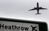 FILE - A plane takes off over a road sign near Heathrow Airport in London, June 5, 2018. (AP Photo/Kirsty Wigglesworth, File)