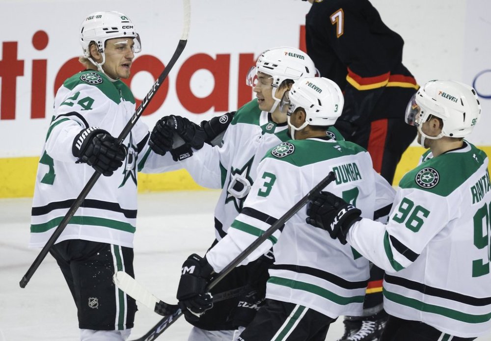 Dallas Stars' Roope Hintz, left, celebrates his goal with teammates during first period NHL hockey action against the Dallas Stars in Calgary on Thursday, March 27, 2025.THE CANADIAN PRESS/Jeff McIntosh