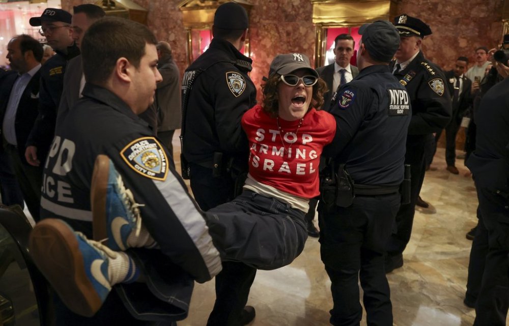 New York Police officers arrest a demonstrator from the group, Jewish Voice for Peace, who protested inside Trump Tower in support of Columbia graduate student Mahmoud Khalil, Thursday, March 13, 2025, in New York. (AP Photo/Yuki Iwamura)