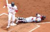 Boston Red Sox's Trevor Story gets tagged out by St. Louis Cardinals catcher Iván Herrera (48) in the second inning during the first baseball game of a doubleheader, Sunday, April 6, 2025, in Boston. (AP Photo/Mark Stockwell)
