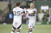 Vancouver Whitecaps midfielder Ryan Gauld (25) and midfielder Sebastian Berhalter (16) react after a missed penalty kick against the Portland Timbers during an MLS soccer game Sunday, Feb. 23, 2025, in Portland, Ore. (AP Photo/Amanda Loman)