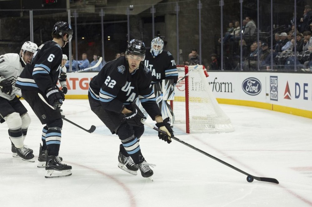 Utah Hockey Club center Jack McBain (22) moves the puck on the ice against Los Angeles Kings during the second period of an NHL hockey game, Thursday, April 3, 2025, in Salt Lake City. (AP Photo/Melissa Majchrzak)