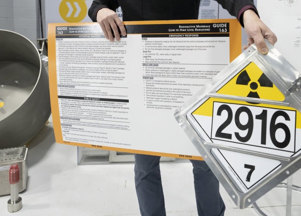 A Nuclear Waste Management Organization senior transportation engineer explains transportation signage and emergency response guide (ERG) pages for waste uranium during a tour of NWMO's facility in Oakville, Ont., Tuesday, Dec. 12, 2023. THE CANADIAN PRESS/Frank Gunn