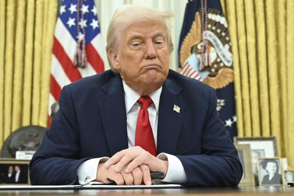 President Donald Trump speaks to reporters before signing an executive order in the Oval Office of the White House in Washington, Monday, March 31, 2025. (Pool via AP)