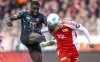 Munich's Dayot Upamecano, left, and Berlin's Andrej Ilic, right, challenge for the ball during the German Bundesliga soccer match between 1. FC Union Berlin and FC Bayern Munich in Berlin, Germany, Saturday, March 15, 2025. (Andreas Gora/dpa via AP)