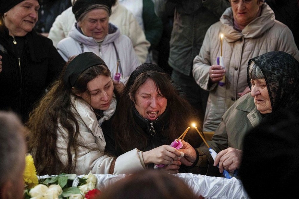 A mother cries at the coffin of her son Herman Tripolets, 9, killed by a Russian missile, during a funeral ceremony in Kryvyi Rih, Ukraine, Monday, April 7, 2025. (AP Photo/Evgeniy Maloletka)