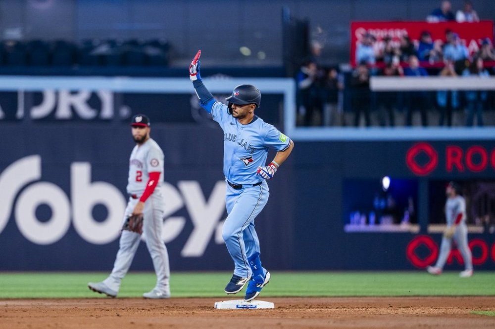 Toronto Blue Jays second base Andrés Giménez (0) celebrates a home run during the second inning of MLB baseball action against the Washington Nationals, in Toronto, Monday, March 31, 2025. THE CANADIAN PRESS/Thomas Skrlj