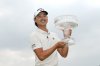 Min Woo Lee, of Australia, holds the championship trophy after winning the Houston Open golf tournament in Houston, Sunday, March 30, 2025. (AP Photo/Ashley Landis)