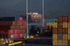 Cargo containers are seen stacked at the Port of Vancouver Centerm container terminal as the container ship MSC Lily sits at anchor in the harbour, in Vancouver, on Friday, Oct. 14, 2022. THE CANADIAN PRESS/Darryl Dyck