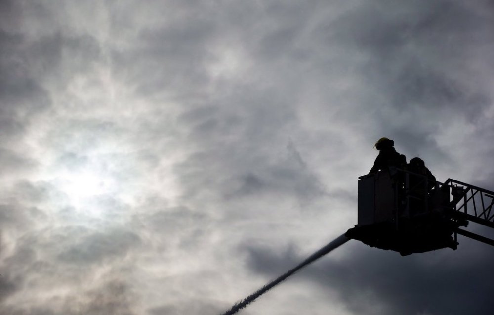 A fire at a high-rise building in downtown Vancouver has displaced 42 residents. Firefighters are silhouetted at an apartment building fire in Burnaby, B.C., on Sunday, Feb. 17, 2013. THE CANADIAN PRESS/Darryl Dyck