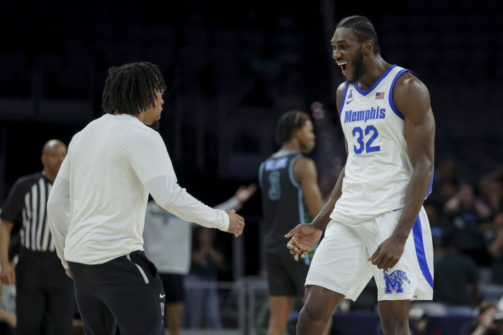 Memphis center Moussa Cisse (32) celebrates during the second half of an NCAA college basketball game against Tulane in the semifinals of the American Athletic Conference tournament, Saturday, March 15, 2025, in Fort Worth, Texas. (AP Photo/Gareth Patterson)