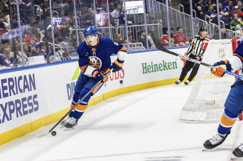 New York Islanders defenseman Noah Dobson (8) skates with the puck during the first period of an NHL hockey game against the Florida Panthers, Sunday, March 16, 2025, in Elmont, N.Y. (AP Photo/Stefan Jeremiah)