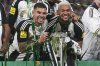 Newcastle's Bruno Guimaraes, left, and Joelinton pose with the trophy after winning the EFL Cup final soccer match between Liverpool and Newcastle at Wembley Stadium in London, Sunday, March 16, 2025. (AP Photo/Scott Heppell)