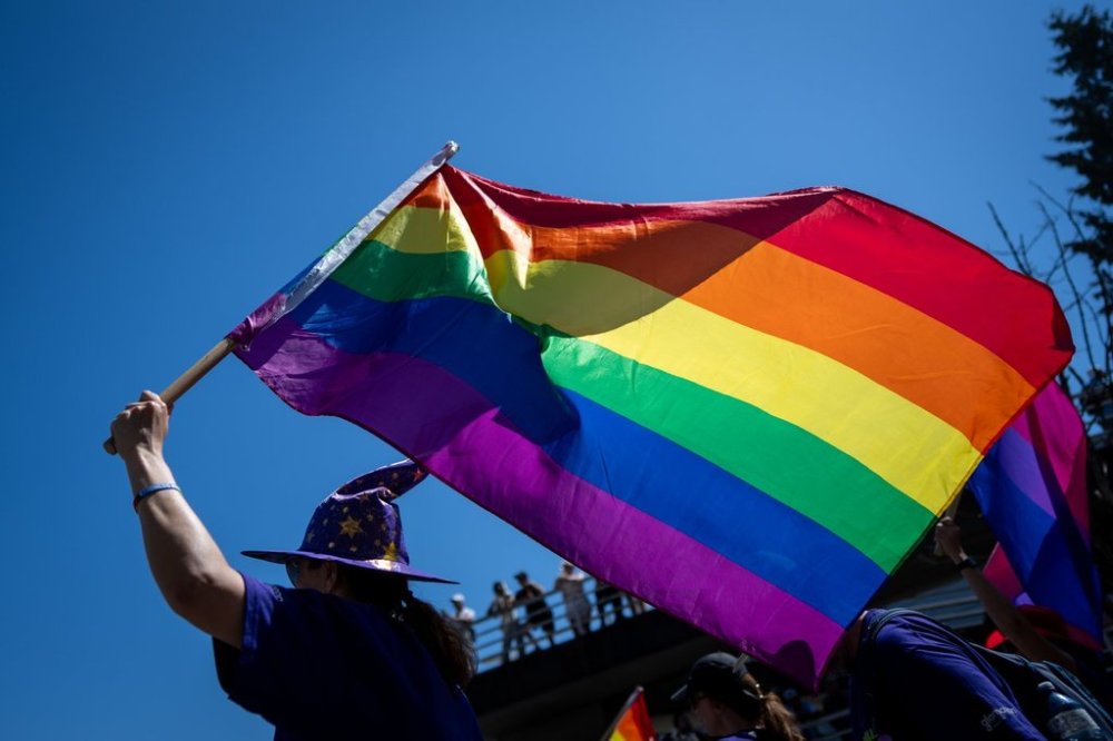 As LGBTQ+ Americans deal with the “scary” reality of living under U.S. President Donald Trump’s administration, a New Brunswick Pride group has invited their neighbours south of the border to join their Pride week celebrations. A person walks with a Pride flag during the Pride Parade in Vancouver, Aug. 4, 2024. THE CANADIAN PRESS/Ethan Cairns