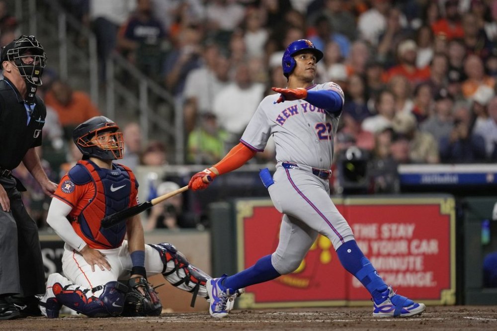New York Mets' Juan Soto (22) hits a home run as Houston Astros catcher Yainer Diaz reaches for the pitch during the third inning of a baseball game Friday, March 28, 2025, in Houston. (AP Photo/David J. Phillip)