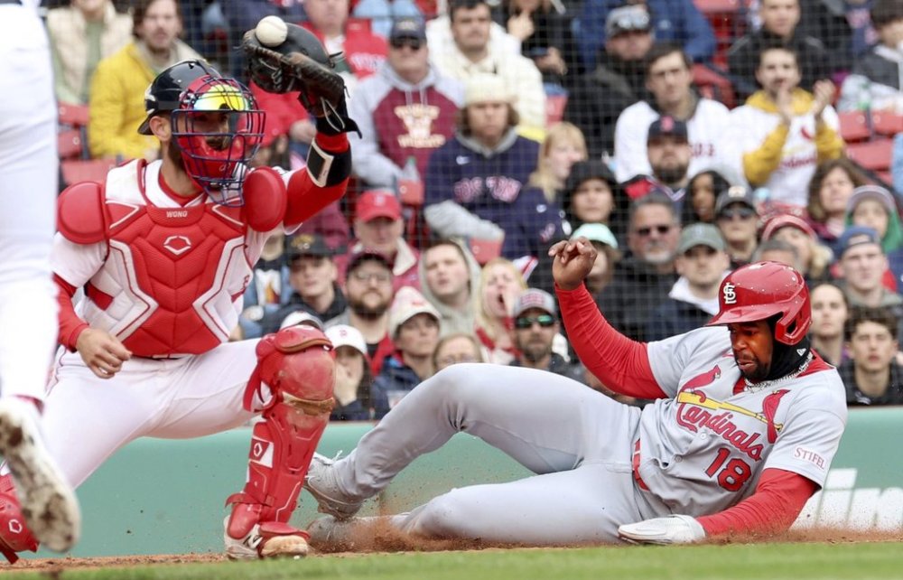 St. Louis Cardinals' Jordan Walker (18) scores at the plate despite an attempted tag by Boston Red Sox catcher Connor Wong in the fourth inning during the first baseball game of a doubleheader, Sunday, April 6, 2025, in Boston. (AP Photo/Mark Stockwell)