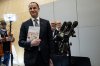 Quebec Minister of Finance Eric Girard displays his 2025-2026 budget plan during a press conference the day before the government's budget is tabled in Quebec City on March 24, 2025. THE CANADIAN PRESS/Karoline Boucher