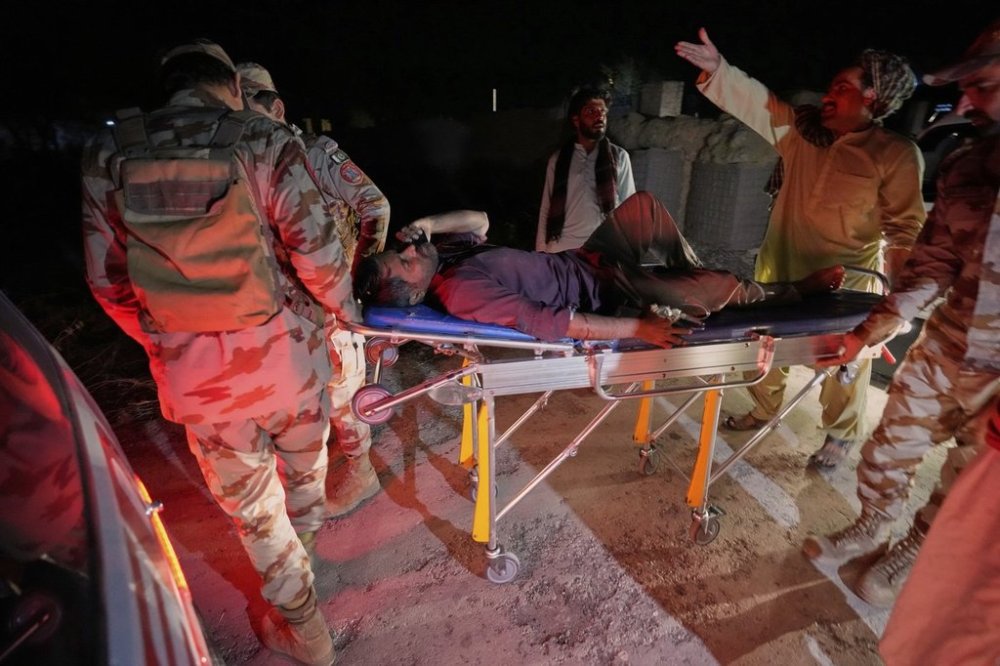 FILE - An injured passenger, rescued by security forces from a passenger train attacked by insurgents, is carried on a stretcher after arriving on a special train for the wounded and survivors, organized by the army, at a railway station in Much, in Pakistan's southwestern Balochistan province, on March 12, 2025. (AP Photo/Anjum Naveed, File)