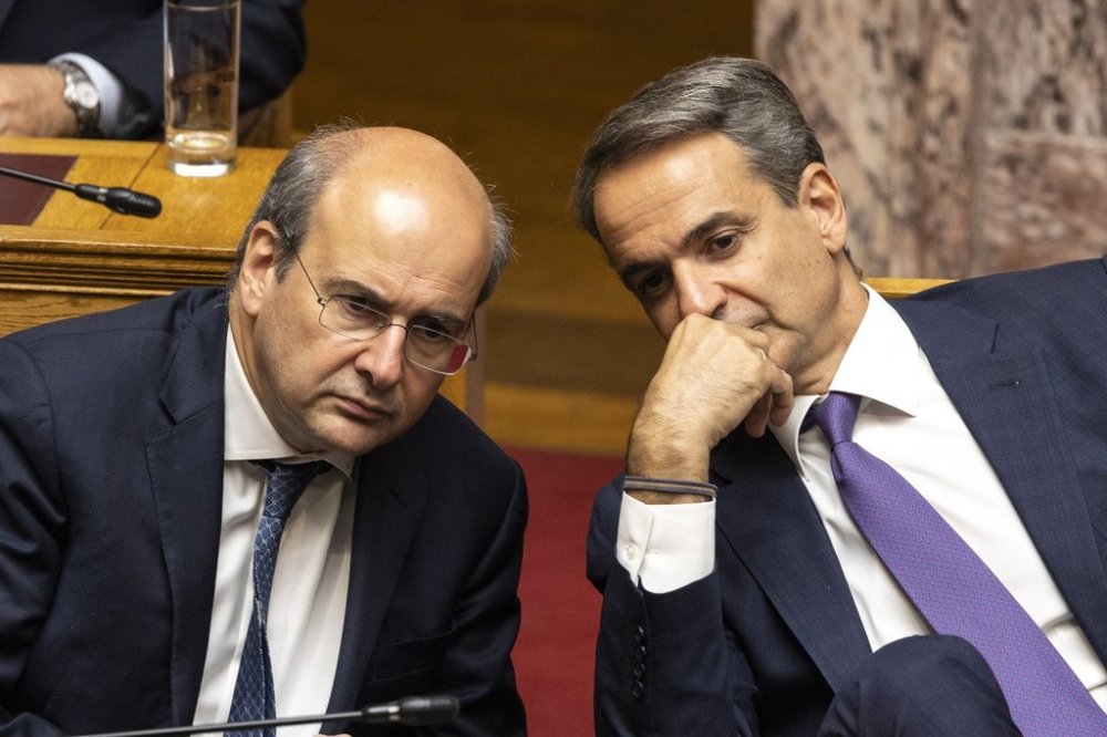 FILE - Greece's Prime Minister Kyriakos Mitsotakis, right, speaks with National Economy and Finance Minister Kostis Hatzidakis during a parliament session in Athens, Greece, Saturday, July 8, 2023. (AP Photo/Yorgos Karahalis, File)