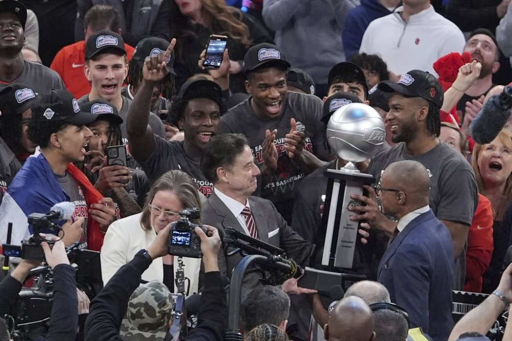 St. John's head coach Rick Pitino admires the tournment trophy after an NCAA college basketball game against Creighton in the championship of the Big East Conference tournament Saturday, March 15, 2025, in New York. (AP Photo/Frank Franklin II)