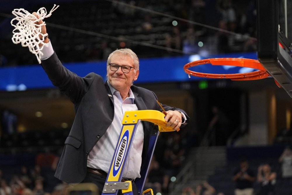 UConn head coach Geno Auriemma holds up the net after defeating South Carolina in the national championship game at the Final Four of the women's NCAA college basketball tournament, Sunday, April 6, 2025, in Tampa, Fla. (AP Photo/John Raoux)