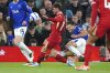Everton's James Tarkowski, left, right Liverpool's Alexis Mac Allister during the English Premier League soccer match between Liverpool and Everton at Anfield, Wednesday, April 2, 2025, in Liverpool, England. (Peter Byrne/PA via AP)