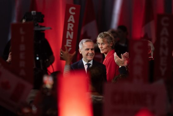 Liberal Leader Mark Carney turns to supporters after it was announced he won the leadership as his wife Diana Fox Carney looks on in Ottawa on Sunday. (Adrian Wyld / The Canadian Press)