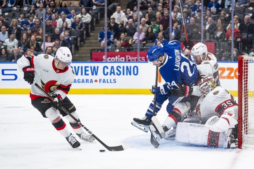 Toronto Maple Leafs left wing Scott Laughton (24) collides with Ottawa Senators goalie Linus Ullmark (35) and defenceman Thomas Chabot (72) as centre Tim Stützle (18) handles the puck during second period NHL hockey action in Toronto on Saturday, March 15, 2025. THE CANADIAN PRESS/Christopher Katsarov