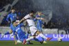 Bologna's Riccardo Orsolini, center, fights for the ball with Empoli's Lorenzo Tosto, left, during the Italian Cup, semi-final, first leg soccer match between Empoli and Bologna at the Renato Castellani stadium, in Empoli, Italy, Tuesday April 1, 2025. (Massimo Paolone/LaPresse via AP)