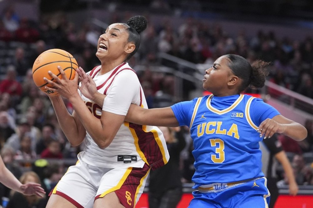 Southern California guard JuJu Watkins, left, grabs a rebound from UCLA guard Londynn Jones (3) during the first half of an NCAA college basketball game in the championship of the Big Ten Conference tournament in Indianapolis, Sunday, March 9, 2025. (AP Photo/Michael Conroy)