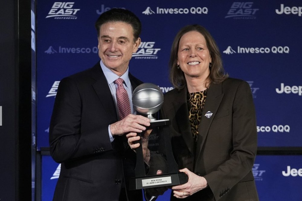St. John's head coach Rick Pitino, left, poses with Big East Conference Commissioner Val Ackerman while holding the Big East Coach of the Year award during a news conference before the Big East basketball tournament Wednesday, March 12, 2025, in New York. (AP Photo/Frank Franklin II)