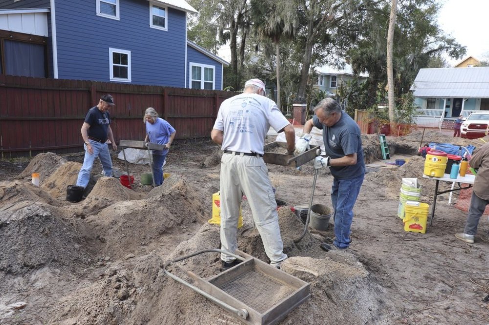 This image provided by the City of St. Augustine Archaeology Program shows City of St. Augustine Archaeology Program volunteers, from left, Don Roberts, Janet Fittipaldi, David Kasriel and Bob Maerz work to screen soil to recover artifacts from the 1781 British Redoubt moat in Feb. 2025. (City of St. Augustine Archaeology Program via AP)