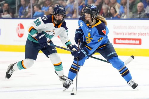 Toronto Sceptres' Daryl Watts, right, takes the puck past New York Sirens' Chloe Aurar during second period PWHL hockey action in Toronto, on Wednesday, March 19, 2025. THE CANADIAN PRESS/Chris Young