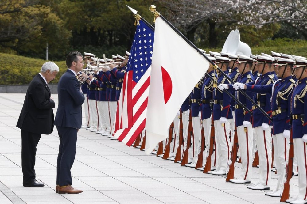 Japan's Defense Minister Gen Nakatani, left, and U.S. Defense Secretary Pete Hegseth review an honor guard during a welcome ceremony at the Ministry of Defense in Tokyo Sunday, March 30, 2025. (Kiyoshi Ota/Pool Photo via AP)