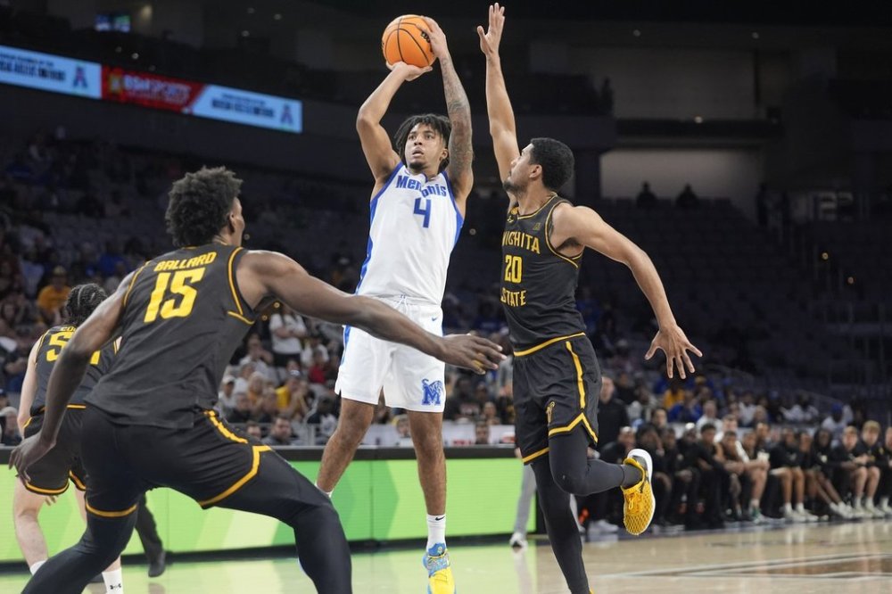 Memphis guard PJ Haggerty (4) shoots over Wichita State guard Harlond Beverly (20) and center Quincy Ballard (15) during the second half in the quarterfinals of the American Athletic Conference tournament in Fort Worth, Texas, Friday, March 14, 2025. (AP Photo/LM Otero)