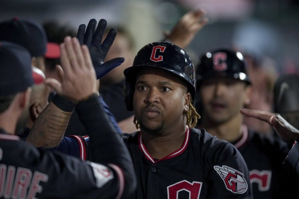 Cleveland Guardians' Jose Ramirez celebrates with teammates in the dugout after hitting a home run during the fifth inning of a baseball game against the Los Angeles Angels in Anaheim, Calif., Friday, April 4, 2025. (AP Photo/Eric Thayer)